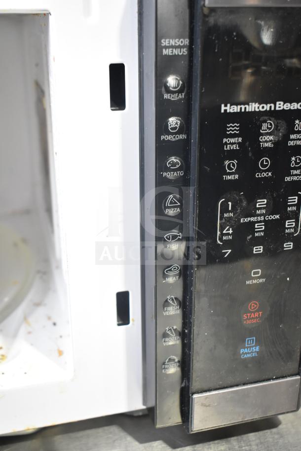 Hamilton Beach HB61B100027880 microwave, 120 volts, visible sensor menus, slight wear. Function buttons include popcorn and reheat.