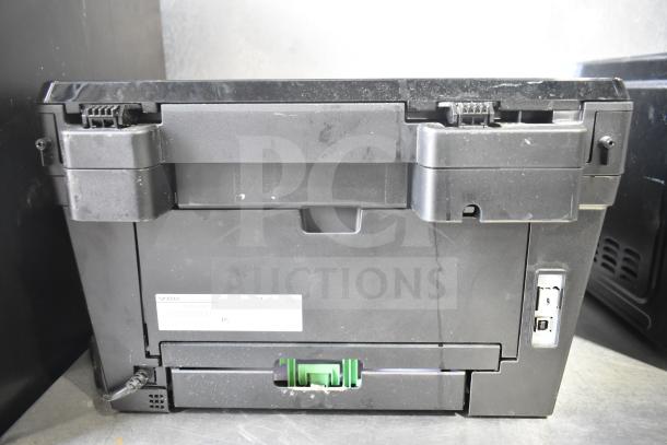 Brother HL-L2380DW printer and scanner, black, used condition, back view showing ports and cable connection.