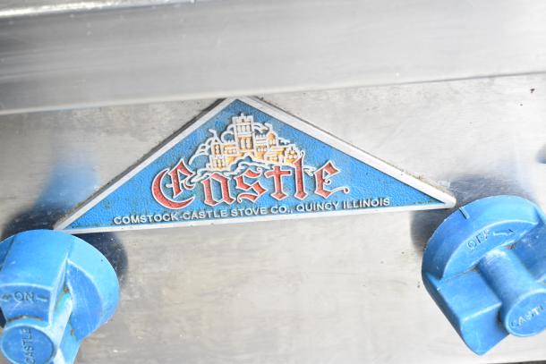 Prince Castle FHP48-2RB charbroiler grill label detail, shows brand name and model. Blue control knobs visible.