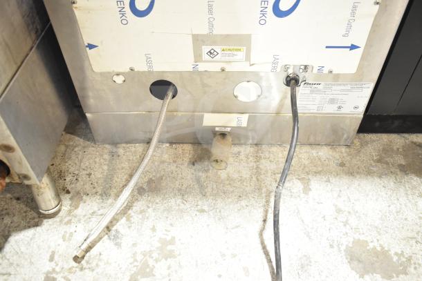 Follett 25CT400A Symphony ice machine rear view; shows connections, caution label, and model information on metal surface.