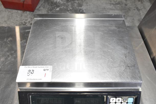 Berkel countertop food portioning scale, 115 volts, 1 phase. Stainless steel surface, minor surface scratches visible.