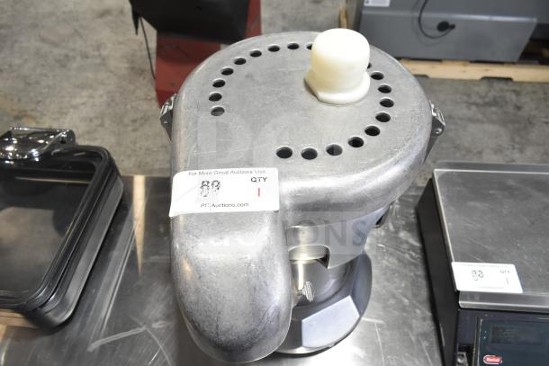 The Ruby 2000 Commercial Citrus Juicer, 115-117 Volts, 1 Phase, stainless steel body, attached auction label.