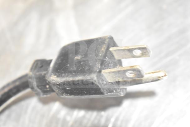 Close-up of a power plug for The Ruby 2000 Commercial Countertop Citrus Juicer, 115-117 Volts, 1 Phase.