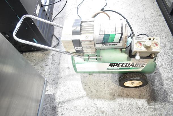 Speedaire 5Z032A Direct Drive Air Compressor, 1 HP, green tank, visible pressure gauges, on wheels, used condition.