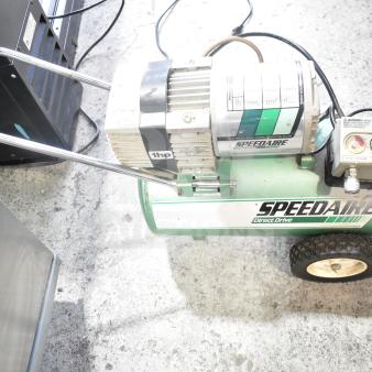 Speedaire 5Z032A Direct Drive Air Compressor, 1 HP, green tank, visible pressure gauges, on wheels, used condition.