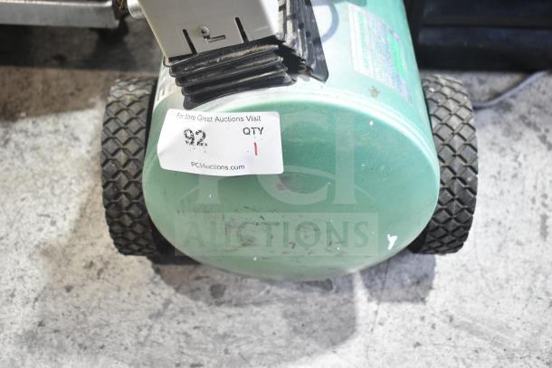 Speedaire 5Z032A Direct Drive Air Compressor with green tank and wheels, showing moderate wear. Auction tag visible.