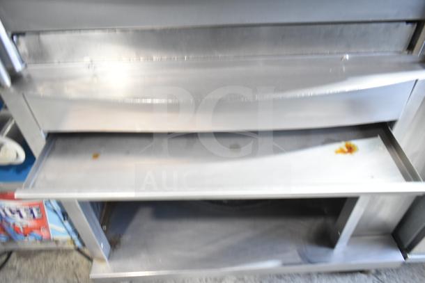 Fri-jado STG 7-P commercial rotisserie oven on casters. Stainless steel exterior, electric, 208V, 3 phase. Visible wear.