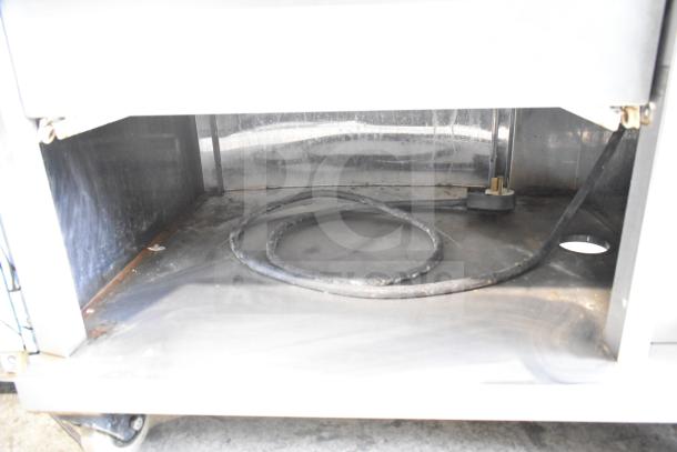 Fri-jado STG 7-P commercial rotisserie oven interior, showing condition. Mounted on commercial casters. 208V, 3 Phase.