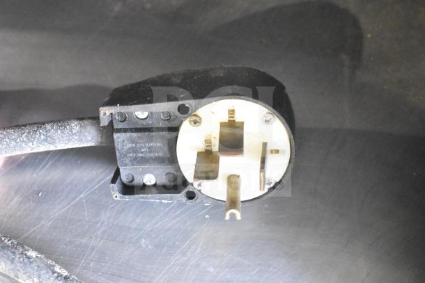 Fri-jado STG 7-P rotisserie oven plug detail, showing 3-prong configuration, compatible with 208V, 3-phase power.