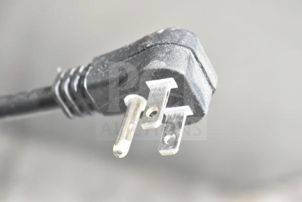 Close-up of a power plug for the Turbo Air M3R47-2-N commercial cooler, showing a three-prong design, 115 volts.