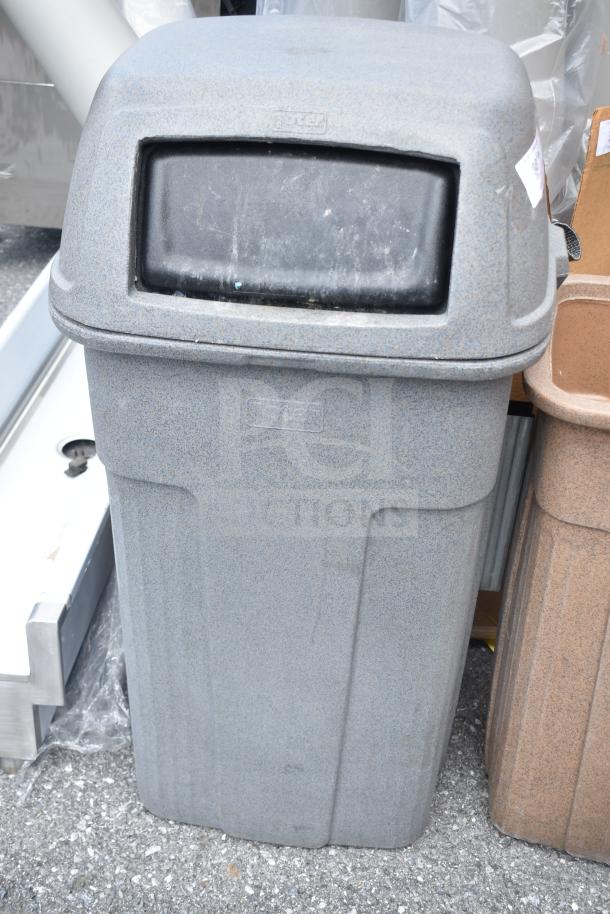 Gray poly trash can with swing lid, textured surface. Brand logo embossed on front. Good condition.