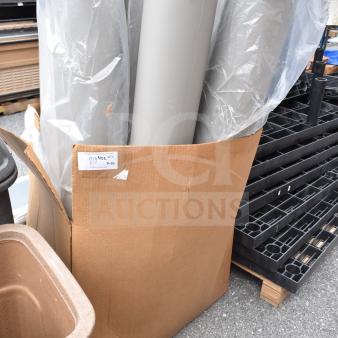 Gray IdealShield bollard covers in a cardboard box, new condition. Tag indicates quantity of 10. Used for protective purposes.