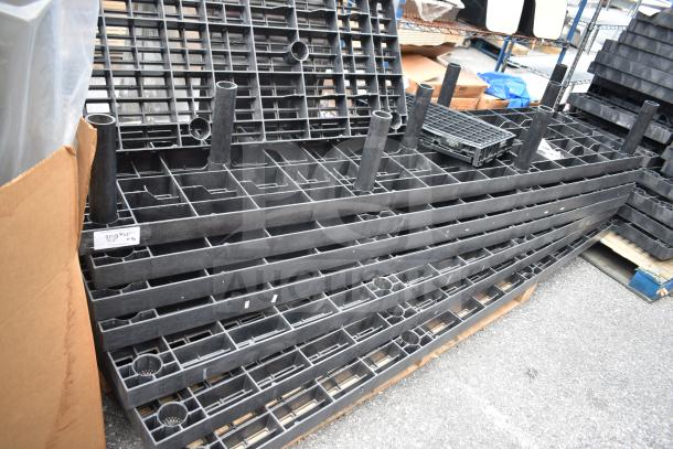 Lot of 7 black poly shelf pieces, sturdy construction, used condition. Features grid design, suitable for storage setups.