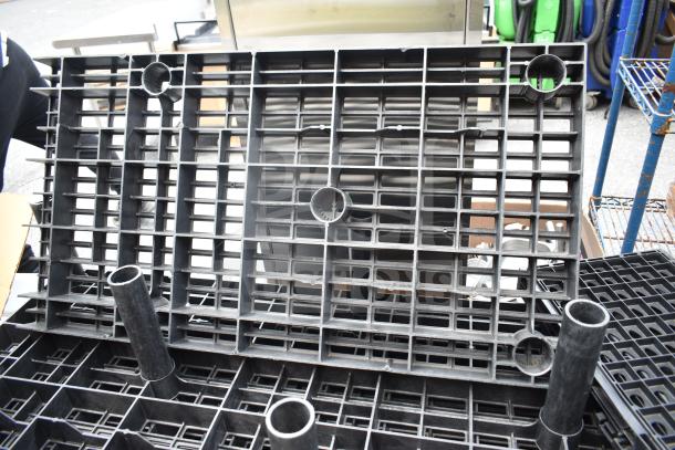 Lot of 7 black poly shelf pieces, grid design, used condition, suitable for industrial storage.