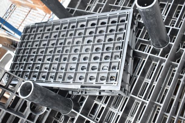 Lot of 7 black poly shelf pieces, grid design, durable plastic. Ideal for industrial shelving, good condition.