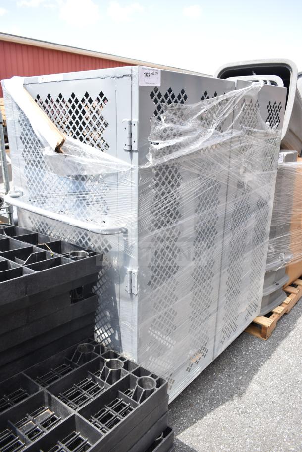 Gray cabinet on commercial casters, metal lattice design, shrink-wrapped, excellent condition, label states '102 42x32 QTY'.