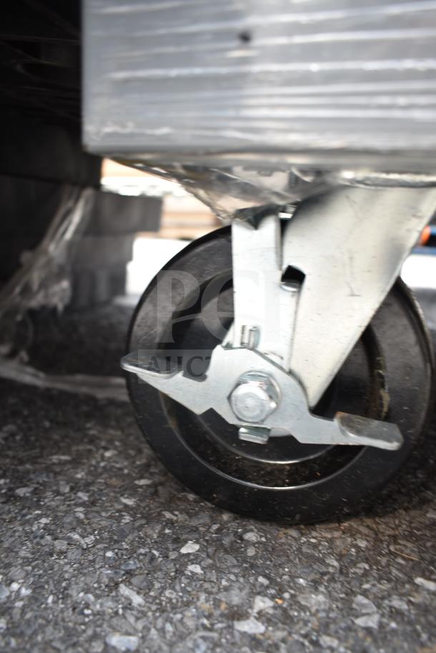 Alt text: Industrial-grade caster wheel on a gray cabinet, highlighting durability and mobility.