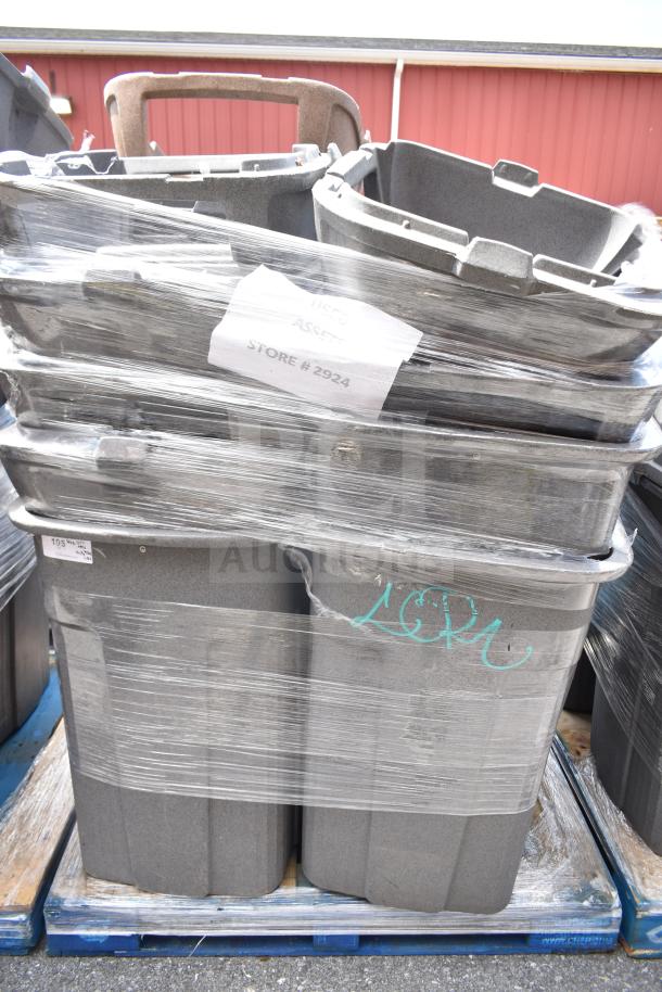 Seven gray plastic trash cans wrapped on a pallet, labeled "Store #2924." Visible markings include inventory tags.