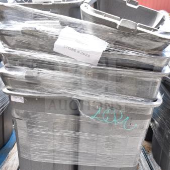 Seven gray plastic trash cans wrapped on a pallet, labeled "Store #2924." Visible markings include inventory tags.