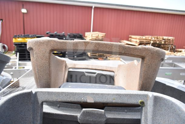 Seven stacked trash cans, various colors, used condition, speckled finish. Auction lot offers times seven bid value.