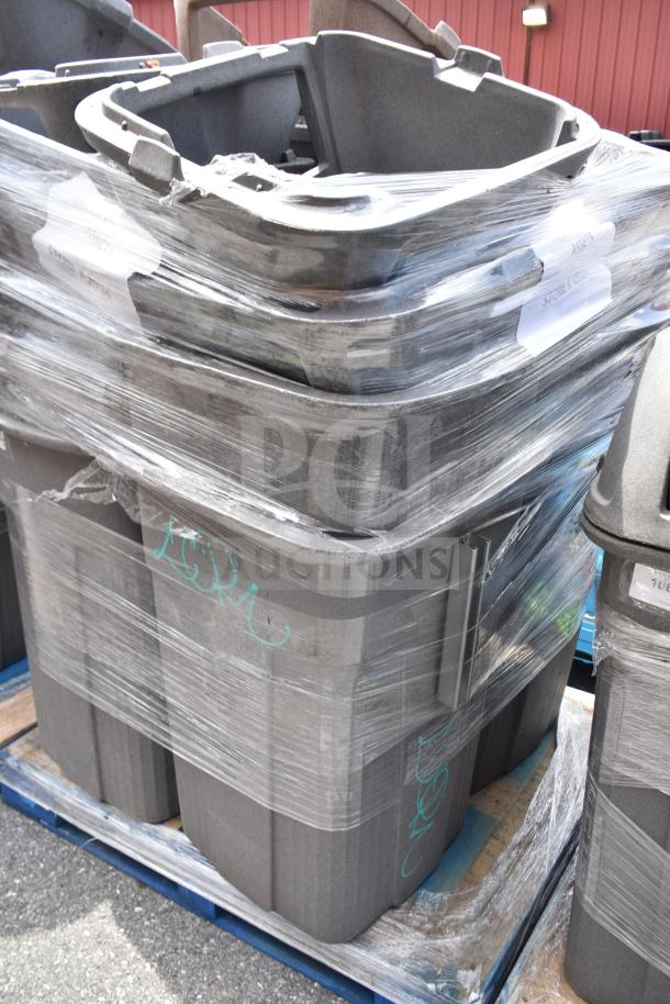 Seven gray trash cans, stackable and wrapped, in good condition on a pallet for auction.
