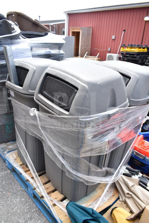 Seven assorted gray trash cans, wrapped on a pallet, suitable for outdoor use, showing light wear.