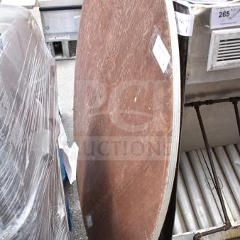Round folding table, wooden surface, dimensions 58x58x3 inches. Visible wear and minor scratches. Auction label attached.