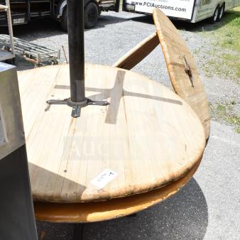 Outdoor display of two wood tables and three table tops, showing wear. Label indicates item 117422.