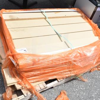 Pallet lot of various items, including secured boards wrapped in orange plastic, and a visible label indicating measurements.