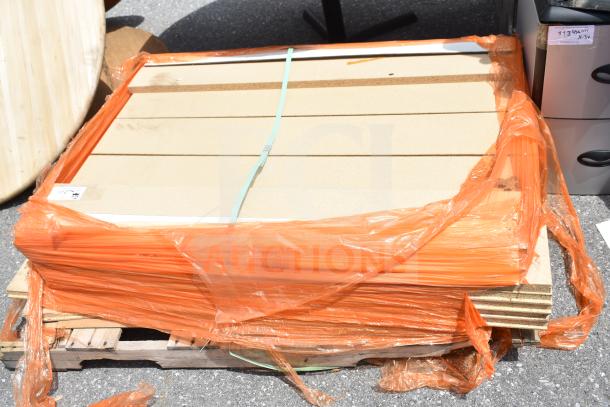 Pallet lot with various items wrapped in orange plastic, including a Shock Watch 2. Items appear in used condition.