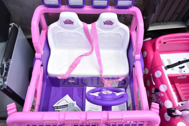 Disney Princess purple and pink ride-on car with white seat and pink seatbelt, plus Minnie Mouse pink polka dot vehicle.