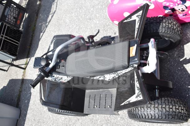 Black Ride On Children's ATV, features padded seat, textured grips, and rugged tires. Minor wear visible on the exterior.