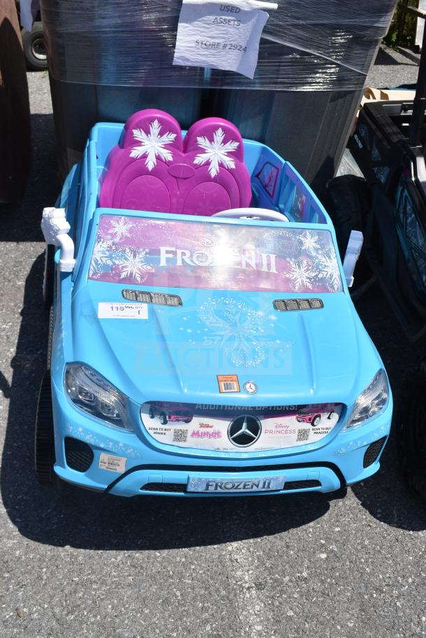 Blue Ride-On Mercedes Frozen II children's car with snowflake graphics, featuring pink seats and Disney branding. Good condition.