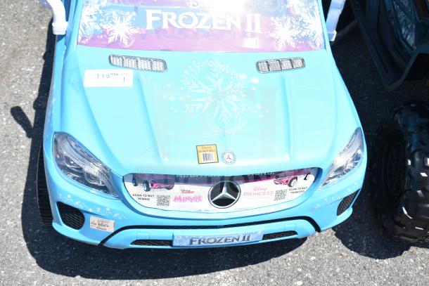 Blue Ride On Children's Mercedes Frozen II car featuring snowflake decals and Disney branding in good condition.
