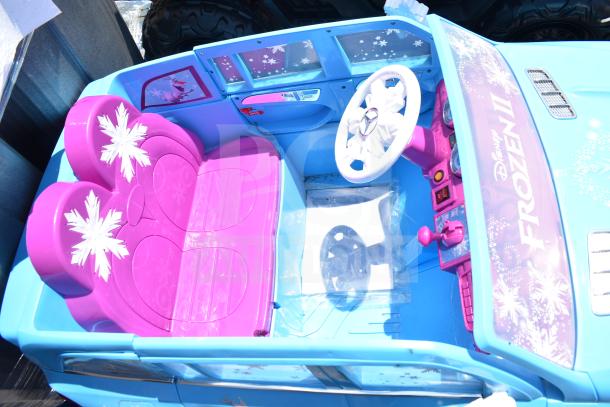 Ride On Children's Mercedes Frozen II Blue Car, featuring pink seats with snowflake designs and Frozen-themed decals, in good condition.