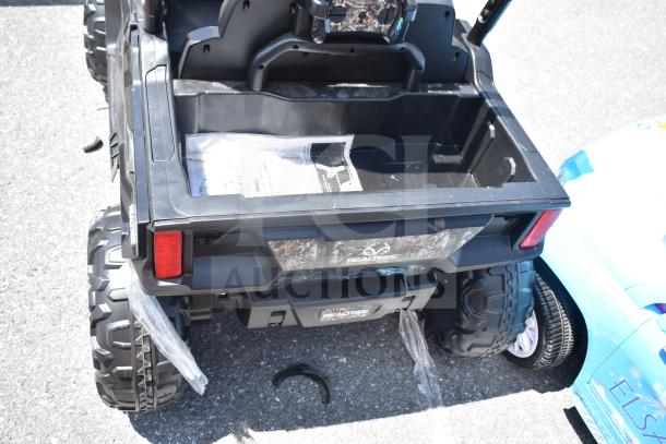 Black Ride On Children's Golf Cart with back storage, Realtree branding, large treaded tires, in like-new condition.