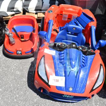 Two children's ride-on vehicles: a Spiderman-themed car and a red hover car. Both in good condition with visible price tag of $158.