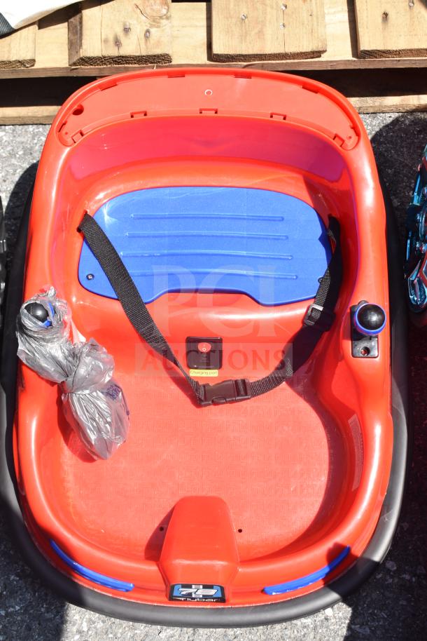 Red children's ride-on hover car with a blue seat, black seatbelt, and charging port label. Good condition.