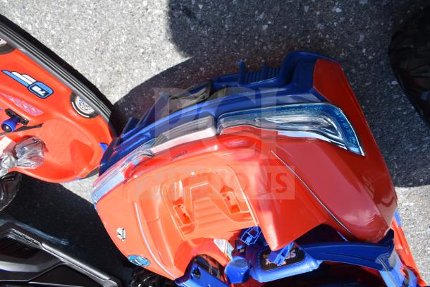 Two children's ride-on vehicles, including a red and blue Spiderman car, featuring bold graphics and plastic body.