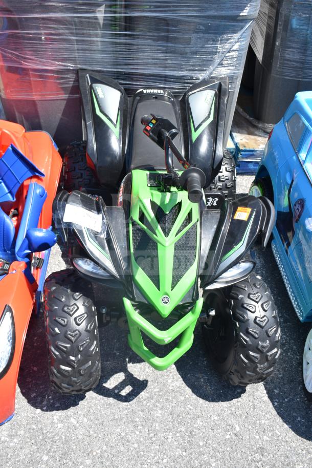 Ride On Children's Raptor ATV, green and black, rugged tires, ergonomic handlebars, visible brand logo, excellent condition.