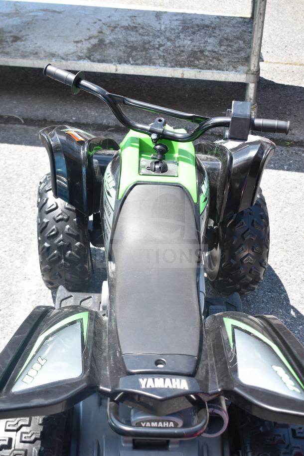 Ride On Children's Raptor ATV, green and black, featuring textured tires, ergonomic handlebars, and Yamaha branding in good condition.