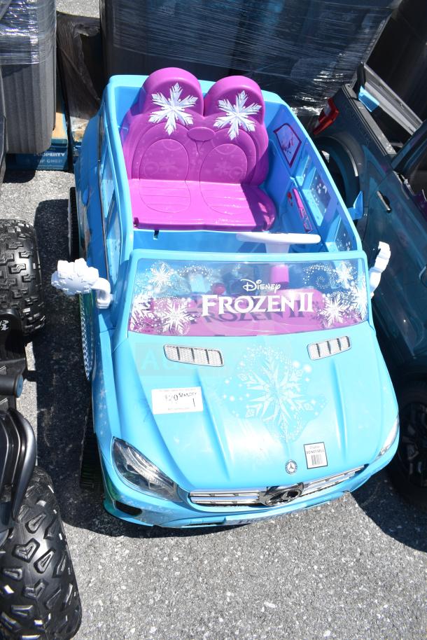 Children's Mercedes Frozen II ride-on blue car with snowflake decals, purple seats, and Mercedes emblem. Great condition.