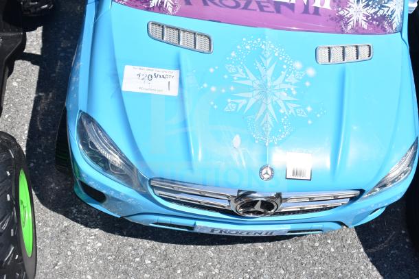 Blue Ride On Children's Mercedes Frozen II car, snowflake design, Mercedes logo on front, auction tag visible.