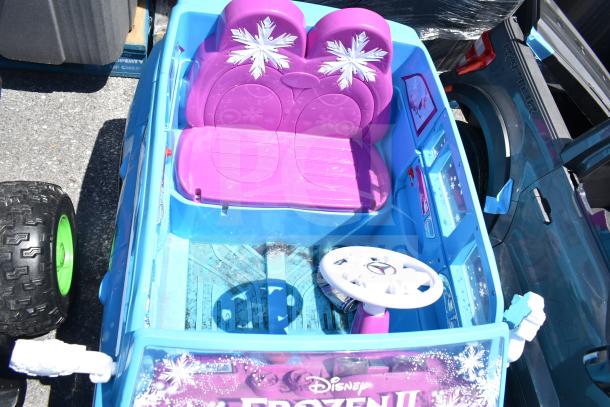 Blue Mercedes Frozen II ride-on car for children, featuring a purple interior with snowflake designs. Good condition.