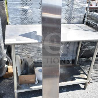 Stainless steel wall mount shelf, in good condition, features pre-drilled installation holes.