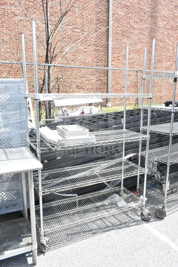 Chrome finish 4-tier wire shelving unit on commercial casters, dismantling required, visible in outdoor setting.