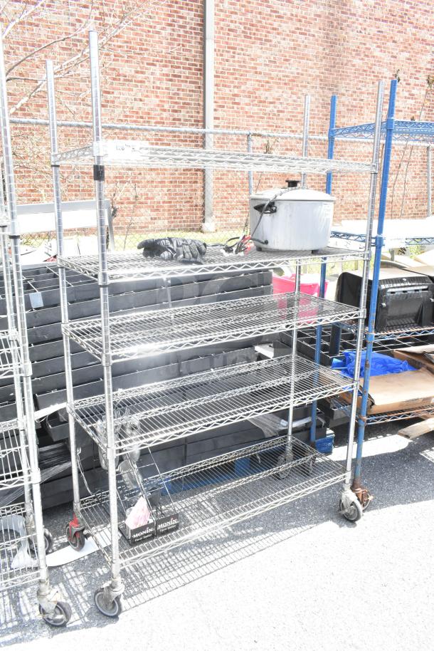 Chrome finish 5-tier wire shelving unit on commercial casters, used condition. Buyer must dismantle. Consider freight charges.
