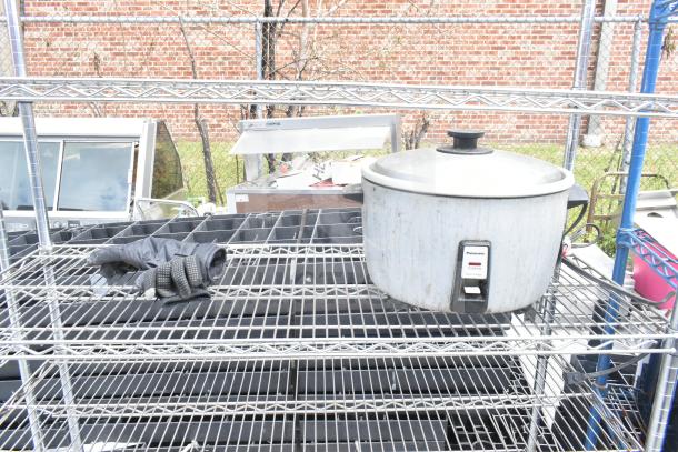 Chrome finish 5-tier wire shelving unit on commercial casters, includes dismantling by buyer; freight charges apply.