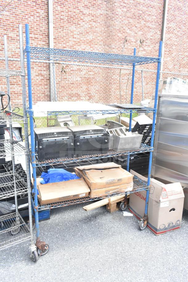 Chrome 4-tier wire shelving unit on casters with contents, visible wear. Buyer must dismantle. Consider freight charges.