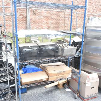 Chrome 4-tier wire shelving unit on casters with contents, visible wear. Buyer must dismantle. Consider freight charges.